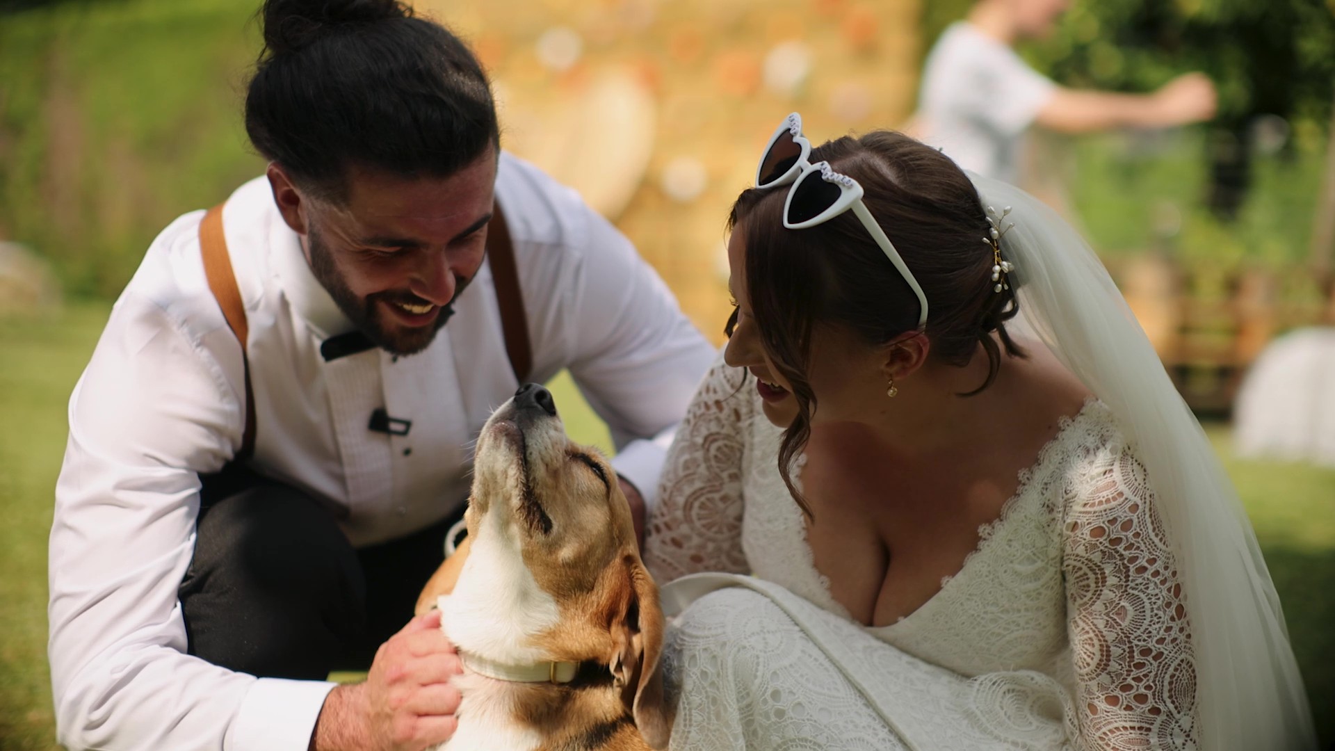Wedding videographer filming candid moment with couple