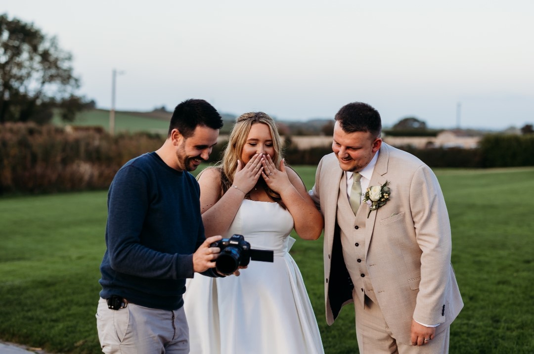 Wedding videographer capturing emotional reactions from couple