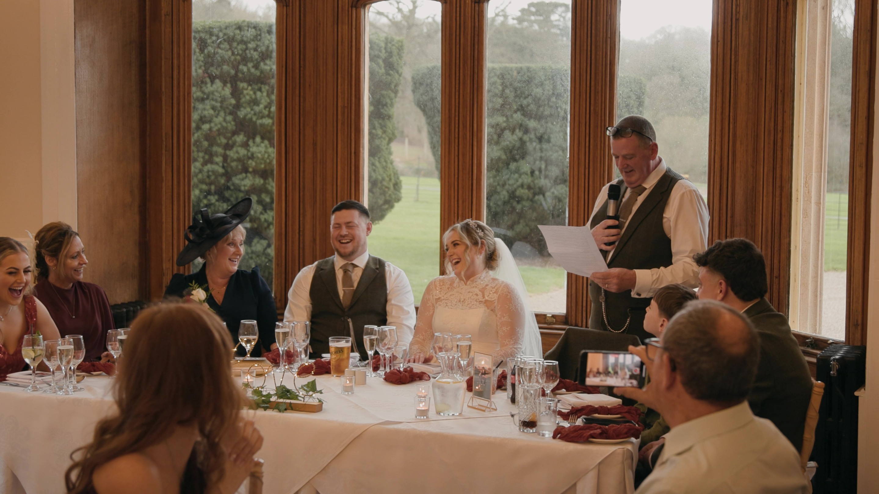 Emotional wedding film moment showing couple reacting to speeches