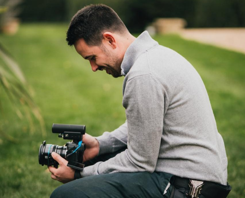 Professional wedding videographer using high end camera equipment during ceremony